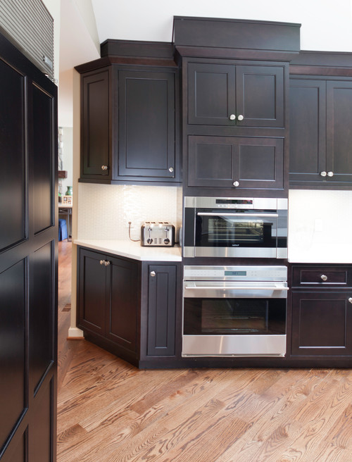 Espresso Stained Cherry Cabinets with Cambria Torquay Countertop, White Matchstick Glossy Backsplash and Oak Flooring
